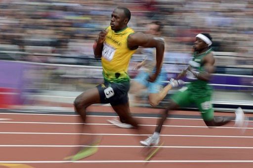 Jamaica&#039;s Usain Bolt (L) and Nigeria&#039;s Noah Akwu (R) compete in the men&#039;s 200m heats