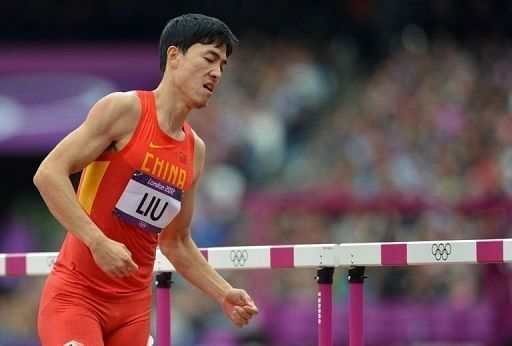 Liu Xiang eventually got up and hopped down the track to be embraced by his fellow competitors