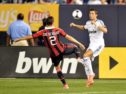 Cristiano Ronaldo (R) of Real Madrid fights for the ball with Mattia De Sciglio of AC Milan, at  Yankee Stadium in N.Y.