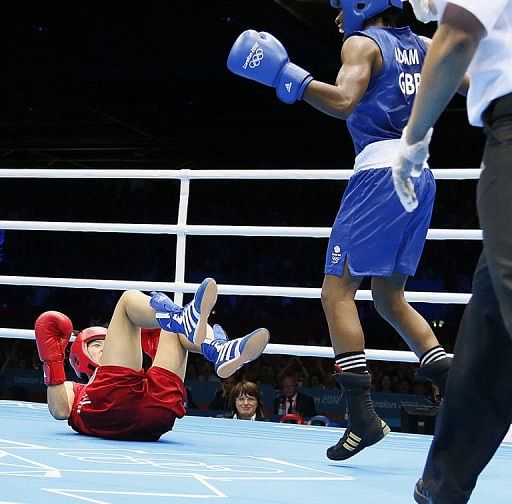 Cancan Ren of China (in red) is knocked down by Nicola Adams of Great Britain