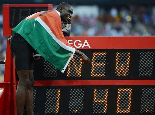 Kenya&#039;s gold medalist David Lekuta Rudisha poses next to the record board after winning the men&#039;s 800 final