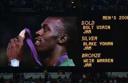 A giant screen shows a picture of Jamaica's gold medalist Usain Bolt celebrating on the podium