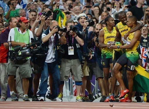 Jamaica&#039;s Usain Bolt (C) celebrates with Yohan Blake (L) and Warren Weir