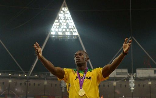 Gold medallist Jamaica&#039;s Usain Bolt stands on the podium after the men&#039;s 200m final