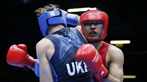 Munkh-Erdene Uranchimeg of Mongolia (in red) fights against Denys Berinchyk of the Ukraine