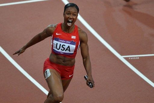 USA&#039;s Carmelita Jeter reacts as she crosses the finish line