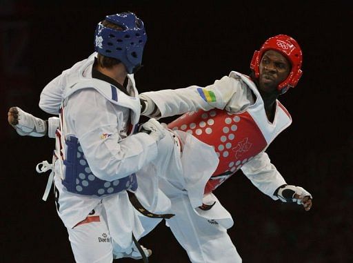 Turkey&#039;s Bahri Tanrikulu (blue) fights against Gabon&#039;s Anthony Obame