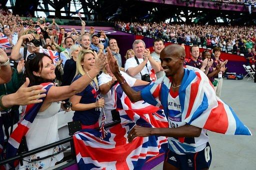 Britain&#039;s Mohamed Farah (R) celebrates with spectators