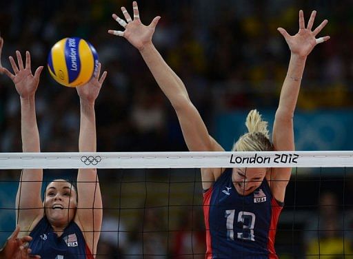 US Lindsey Berg (L) and Christa Harmotto try to block the ball