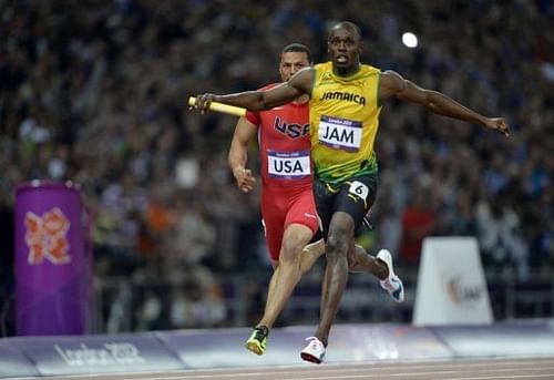 Jamaica's Usain Bolt crosses the finish line ahead of USA's Ryan Bailey