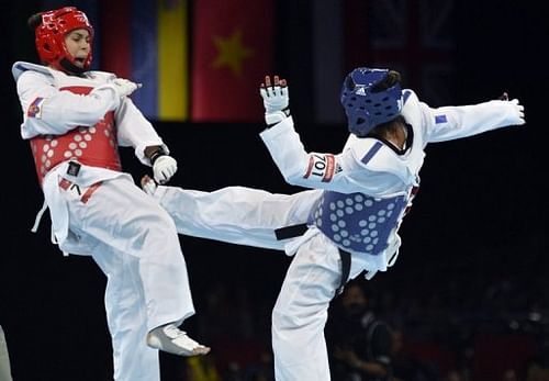 France's Anne-Caroline Graffe (blue) fights against Serbia's Milica Mandic