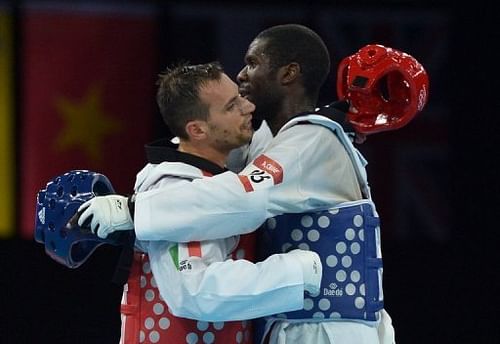 Gabon's Anthony Obame (R) embraces Italy's Carlo Molfetta