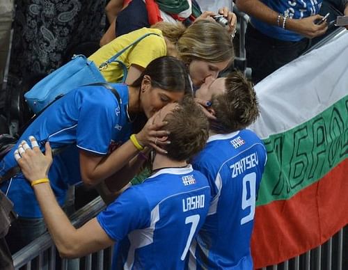 Italy's Michal Lasko (left) and Ivan Zaytsev kiss their girlfriends after defeating Bulgaria