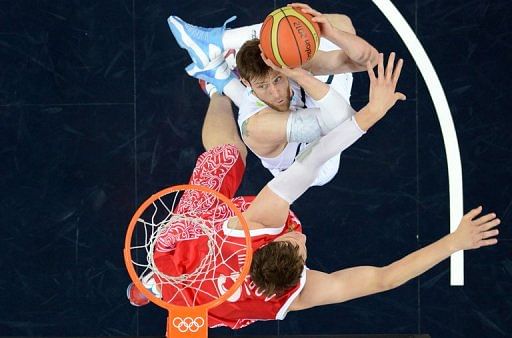 Argentinian forward Andres Nocioni (right) tries to shoot past Russian centre Timofey Mozgov