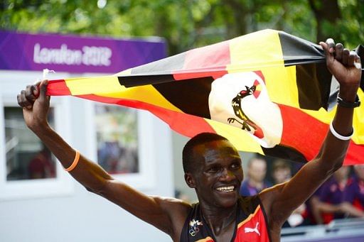 Uganda&#039;s Stephen Kiprotich crossed the finish line waving his national flag