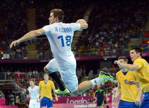 France&#039;s William Accambray jumps to shoot during the men&#039;s gold medal handball match