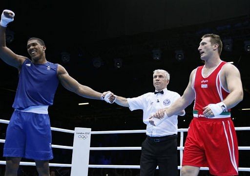 Anthony Joshua of Great Britain is declared gold medal winner over Roberto Cammarelle of Itay