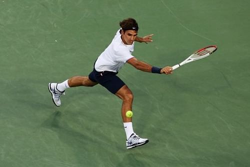 Roger Federer of Switzerland hits a backhand against Alex Bogomolov of Russia