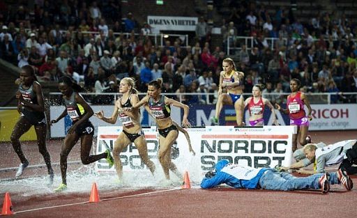 Athletes compete during the women&#039;s 3000m steeplechase race