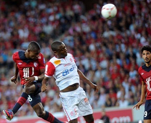 Lille&#039;s Salomon Kalou (L) heads the ball to score a goal