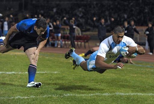 Argentinian Pumas&#039; wing Manuel Montero (right) dives to score a try