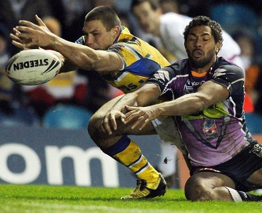 Melbourne Storm centre Michael Auld (right) is denied a scoring opportunity by Rhinos winger Ryan Hall (left) in 2010