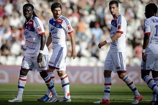 L-R: Lyon&#039;s French striker Bafetimbi Gomis, Serbian defender Milan Bisevac and French midfielder Maxime Gonalons