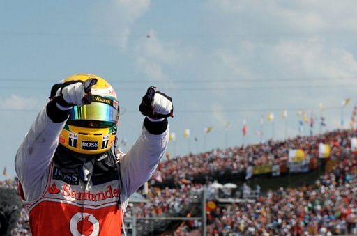 McLaren Mercedes&#039; British driver Lewis Hamilton celebrates celebrates a win in July