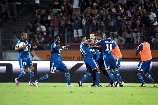 Lyon&#039;s Brazilian midfielder Michel Fernandes Bastos (3rdL) is congratulated by teammates