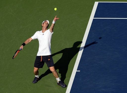 Andy Murray of Britain serves to Alex Bogomolov of Russia