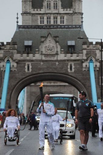 The Paralympic flame is carried across London's Tower Bridge