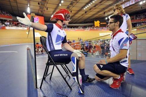 Britain's Jody Cundy (L) talks with para-cycling coach Chris Furber (R) after being denied a restart