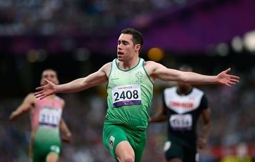 Ireland's Jason Smyth reacts as he crosses the finish line to win the Men's 100 metres T13