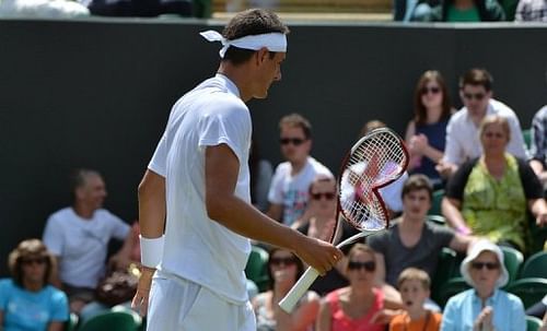 Bernard Tomic smashed his racket into the turf after losing to Belgian David Goffin at the Wimbledon