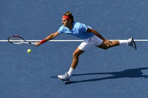 Roger Federer is into the US Open quarter-finals without hitting a ball as American opponent Mardy Fish withdraws