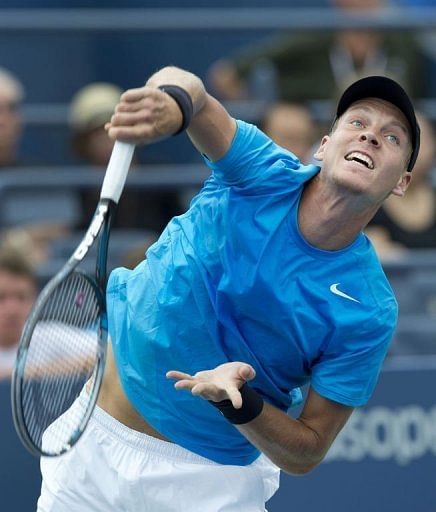 Tomas Berdych of the Czech Republic hits a serve to Nicolas Almagro of Spain
