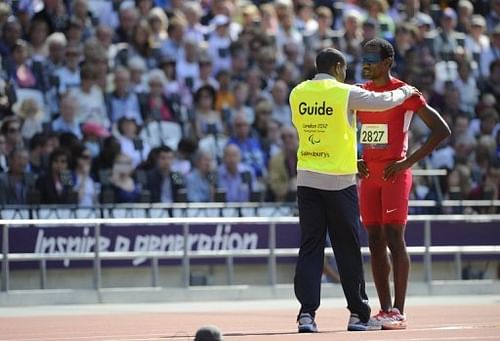 US athlete Elexis Gillette is prepared by his guide to compete in the men's long jump F11 final