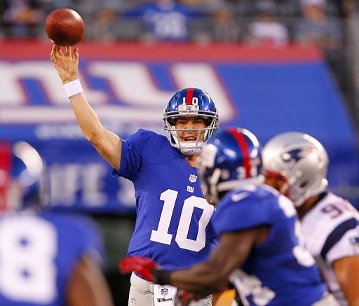 Eli Manning of the New York Giants makes a pass against the New England Patriots during a NFL pre-season game