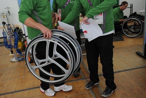 Technicians at the wheelchair orthotic and prosthetic repair centre carry out repairs on wheelchairs