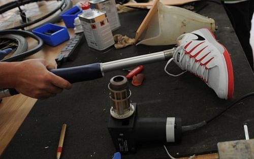 A technician works on a prosthetic leg at a repair centre for prosthetics and wheelchairs