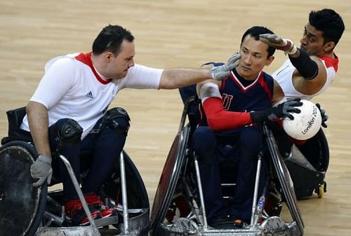 Britain's Ross Morrison (L) and Mandip Sehmi (R) attempt to strip the ball from Will Groulx of the US (C)