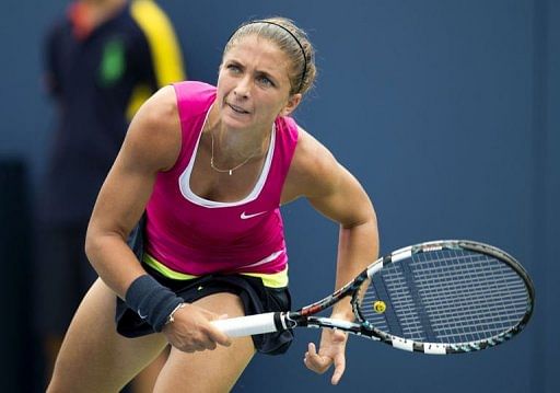 Sara Errani of Italy hits a serve to Roberta Vinci of Italy