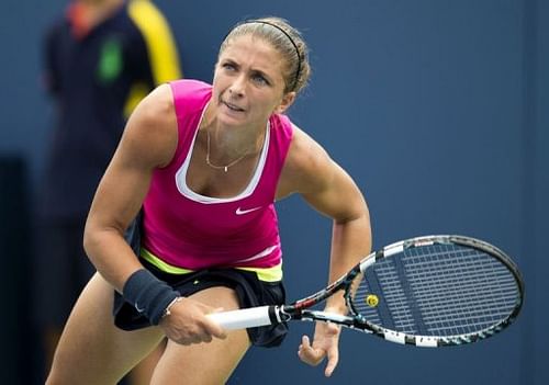 Sara Errani of Italy hits a serve to Roberta Vinci of Italy