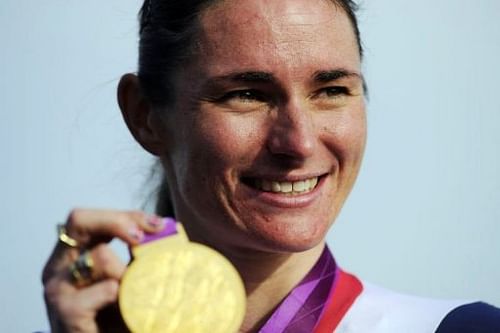 Sarah Storey poses on the podium with her gold medal