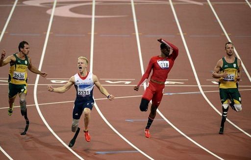 Britain&#039;s Jonnie Peacock (2nd L) reacts to winning the men&#039;s 100m T44 final