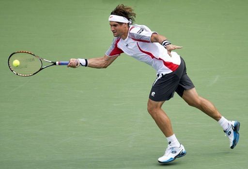 David Ferrer of Spain hits a return to Janko Tipsarevic of Serbia