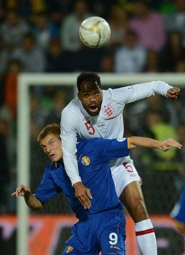 Lescott Joleon (R) of England jumps for the ball with Piscusciac Igor of Moldova