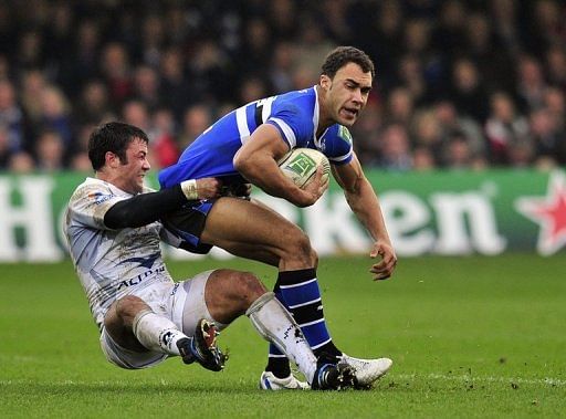 Bath&#039;s winger Olly Woodburn (right) is tackled by Montpellier Herault centre Paul Bosch