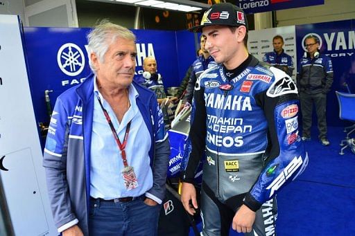 Spanish rider Jorge Lorenzo of the Yamaha factory team (R) chats with multi-time world champion rider, Giacomo Agostini