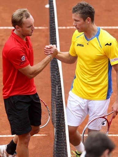 Belgian Steve Darcis (L) shakes hands with Swedish Michael Ryderstedt